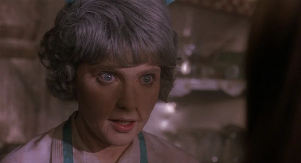 A Nightmare On Elm Street 4: The Dream Master (1988) movie still: closeup — A dimly lit room provides the backdrop for a close-up character…