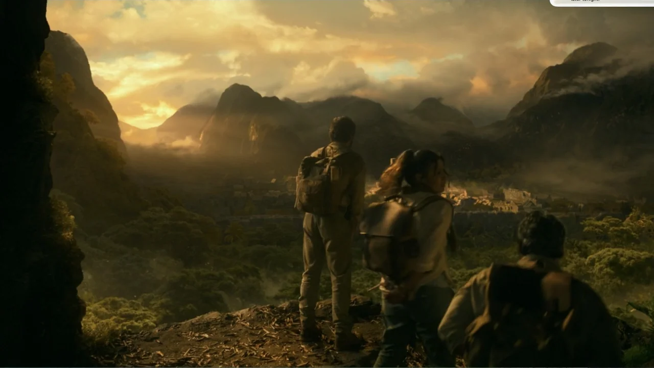 Dora and the Lost City of Gold (2019) movie still: wide — A group of three travelers overlooks a distant valley town from a rocky precipice. The…