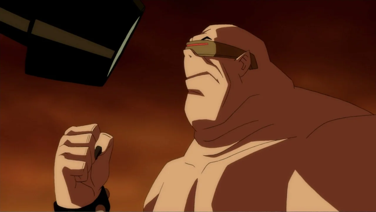 Batman: The Dark Knight Returns, Part 1 (2012) movie still: medium — A dark, cramped space features warm, reddish-brown lighting tones across the…