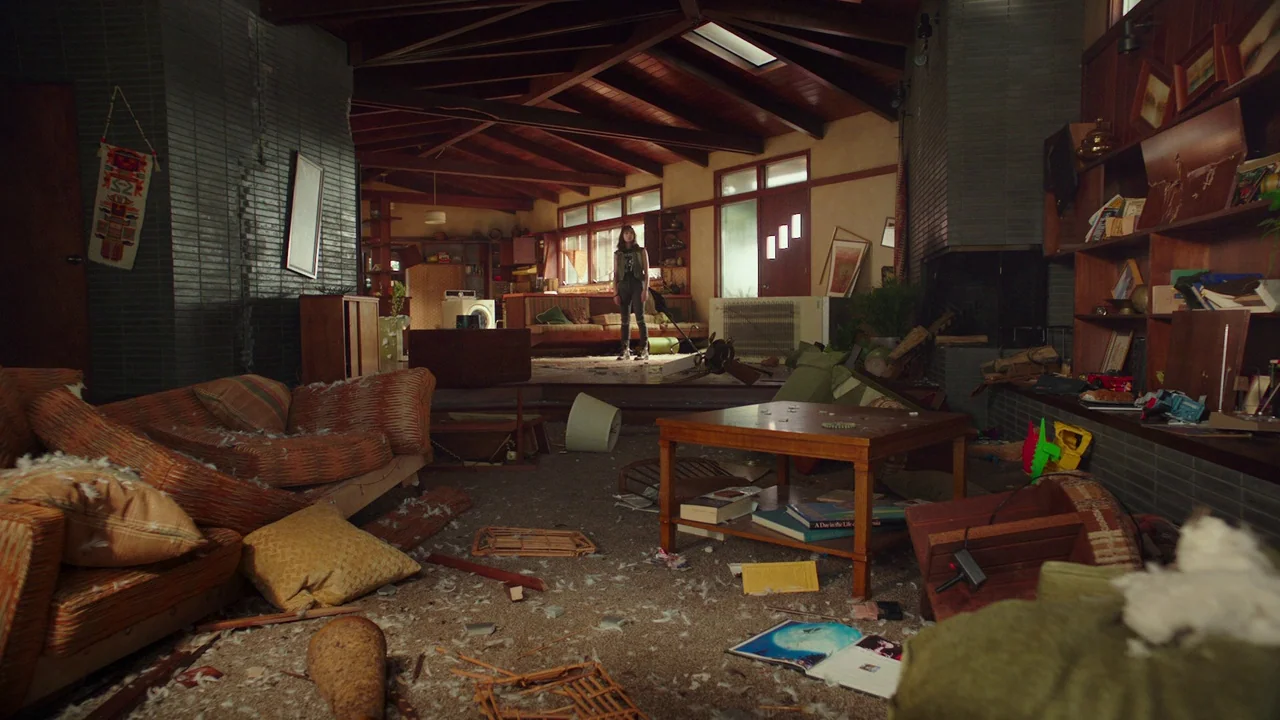 Bumblebee (2018) movie still: wide — A spacious mid-century modern home interior lies in total disarray with debris scattered everywhere. A young…