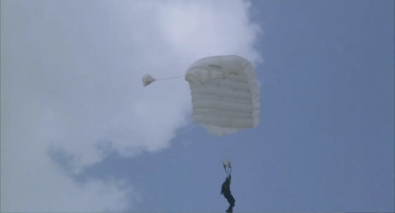 American Ninja 4: The Annihilation (1990) movie still: wide — An open expanse of blue sky with soft white clouds fills the background. A lone…