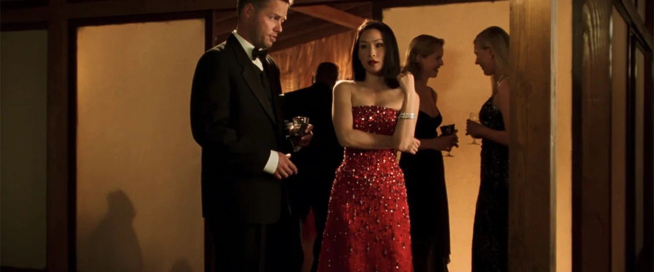 Charlie's Angels (2000) movie still: medium — An interior space features wood-paneled walls and people standing in formal evening attire. A man and…