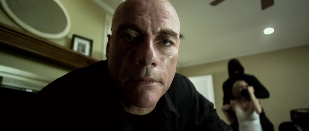 Universal Soldier: Day of Reckoning (2012) movie still: closeup — A residential room features light-colored walls, a wooden mantel, and a ceiling…