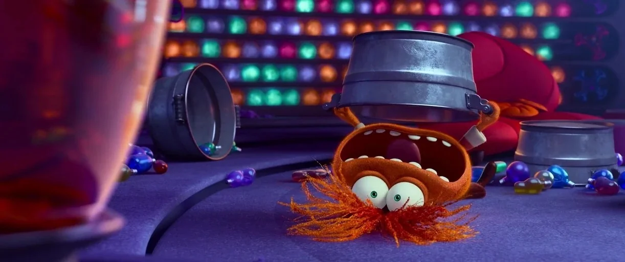 Inside Out 2 (2024) movie still: medium — A room with glowing multicolored circular wall lights and a purple floor surface. A fuzzy orange creature…