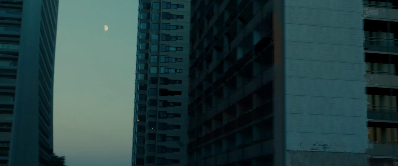 BPM (Beats Per Minute) (2017) movie still: establishing — A dense urban residential area features two tall, multi-story apartment buildings. A…