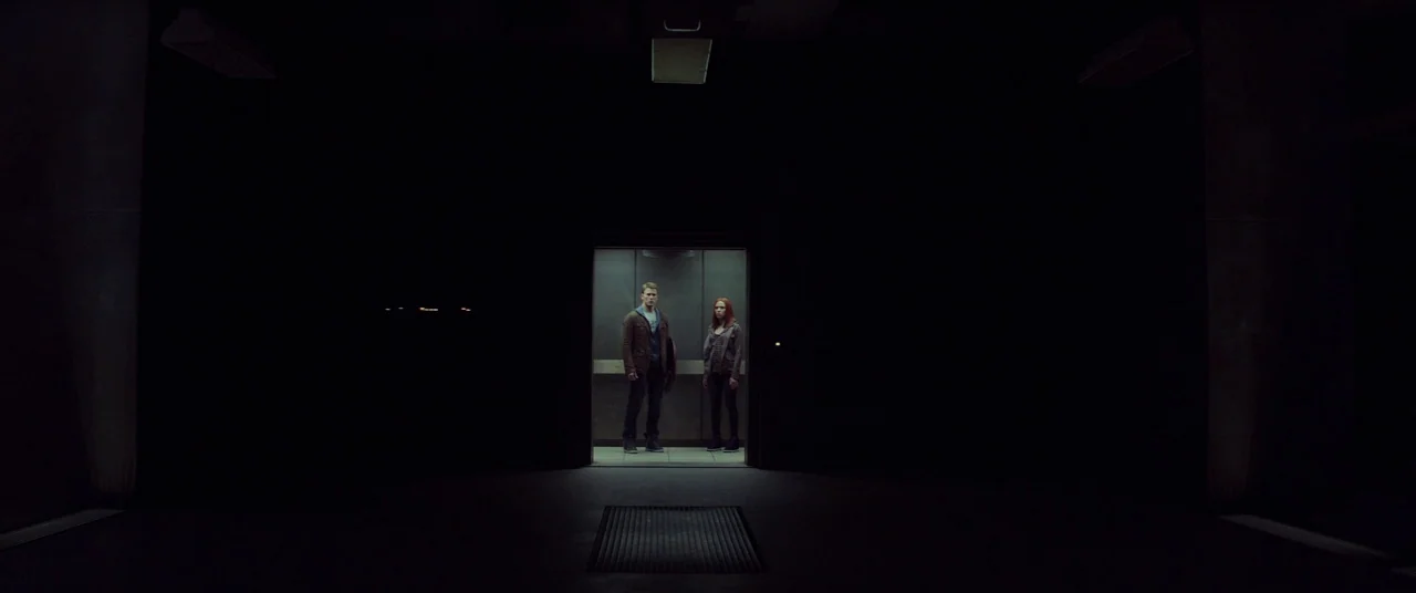 Captain America: The Winter Soldier (2014) movie still: wide — A dark, expansive industrial space surrounds a single illuminated metal elevator…
