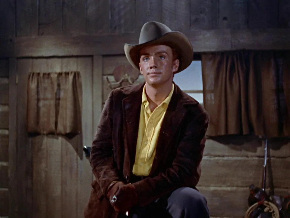 Johnny Guitar (1954) movie still: medium — A rustic log cabin interior features rough wooden walls and a small window.