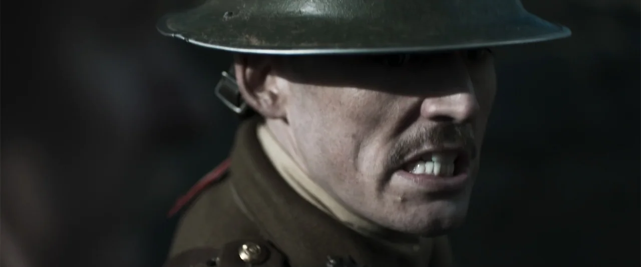 Gone Missing -  Old John's Final Journey (2014) movie still: closeup — A close view of a soldier in a World War I uniform with a helmet. The man has…