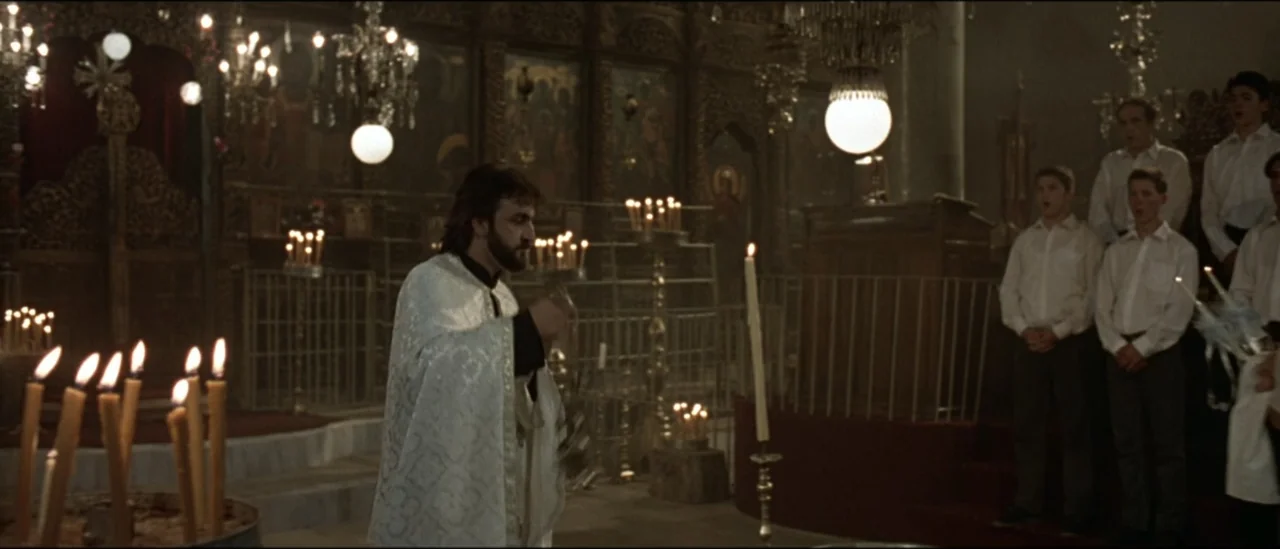 The Peacemaker (1997) movie still: medium — An interior Orthodox church features elaborate iconostasis and lit candles throughout the space. A…