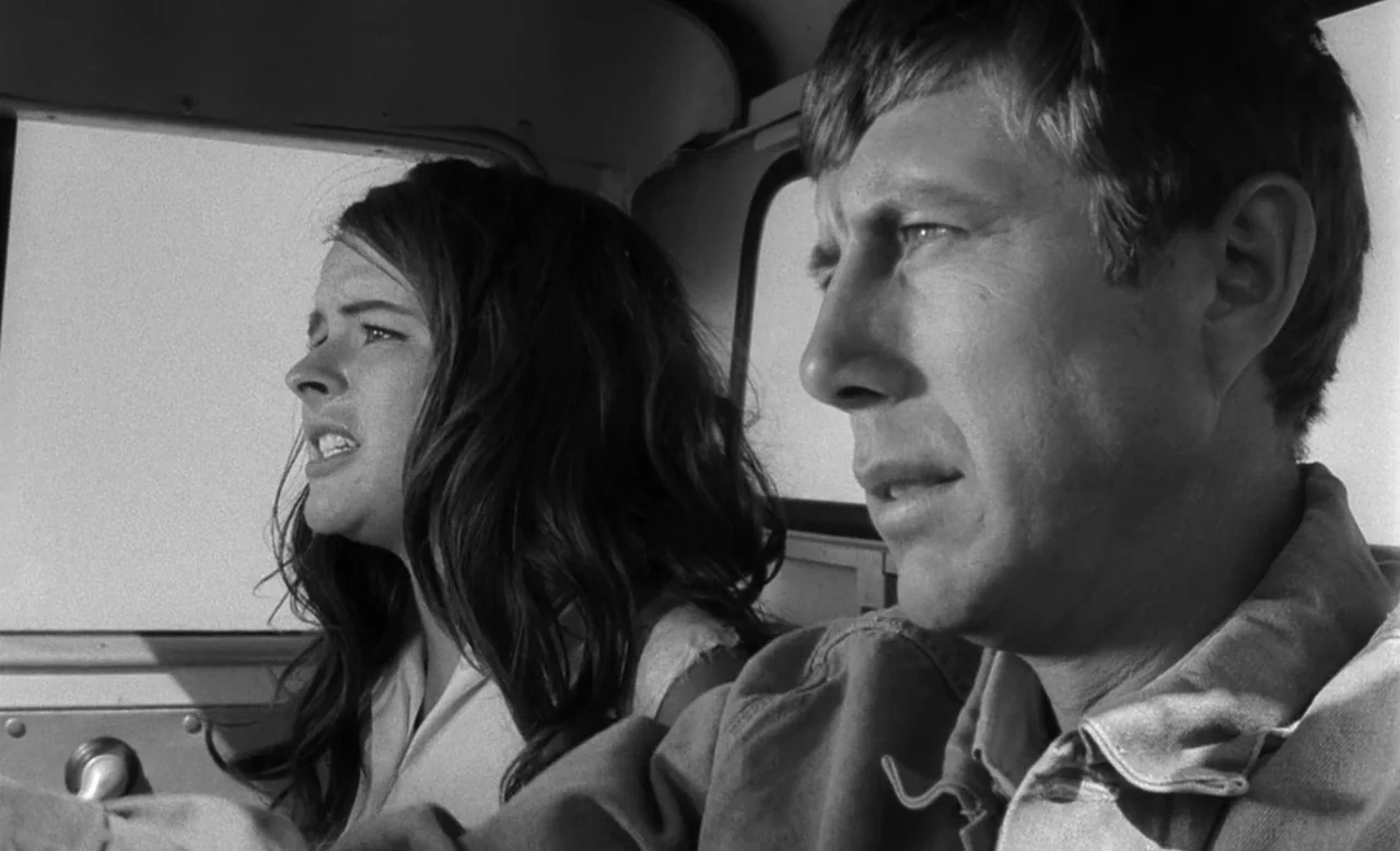 Faster, Pussycat! Kill! Kill! (1965) movie still: medium — The interior of a moving vehicle with windows visible in the background. A man and a…