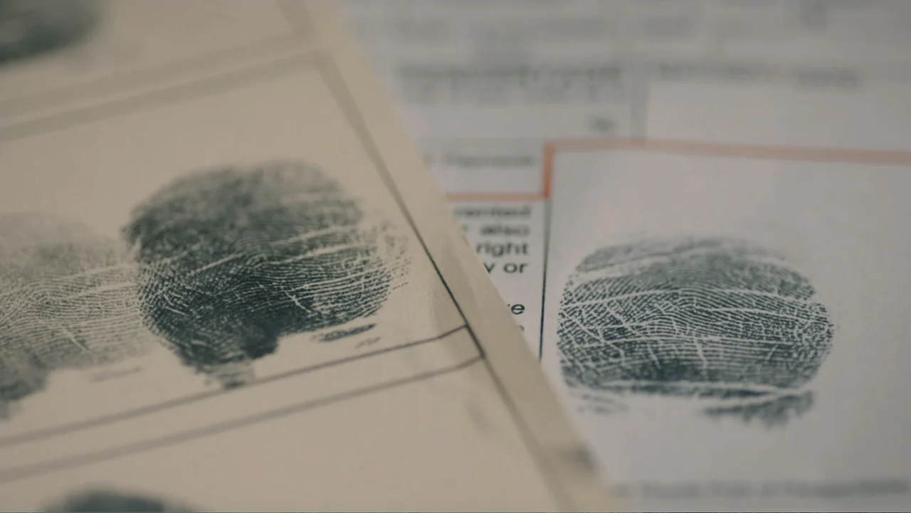 Aileen Wuornos : Mind of a Monster (2020) movie still: closeup — Several fingerprint cards rest on top of a stack of printed paperwork. Each card…