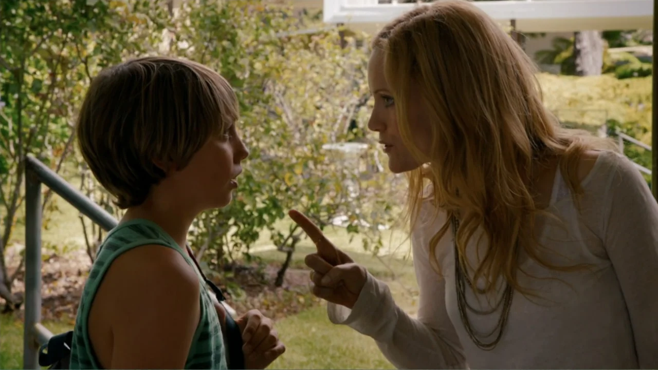 This Is 40 (2012) movie still: medium — A woman and a young boy stand facing each other outdoors. The woman points a finger at the boy during an…