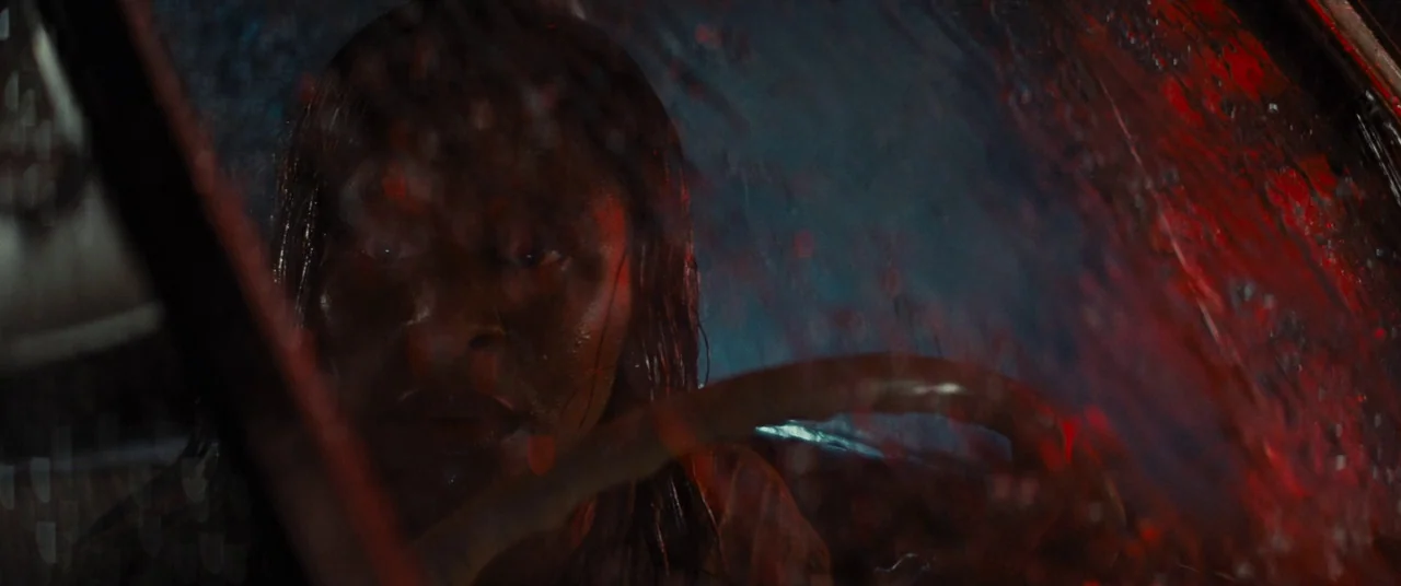 Bad Times at the El Royale (2018) movie still: closeup — The interior of a vehicle at night during a rainstorm. The driver looks through the…