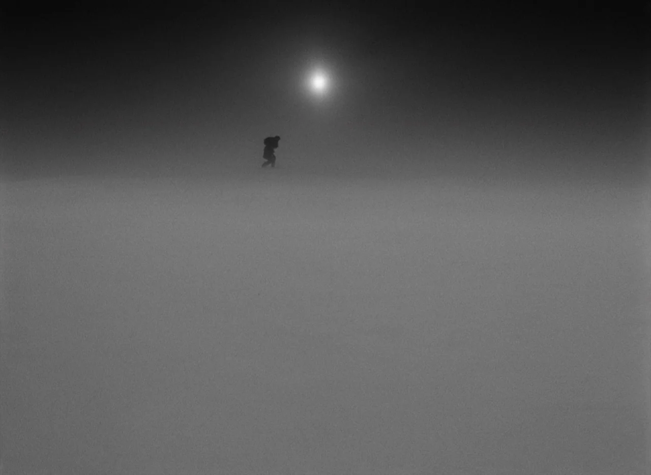 Letter Never Sent (1960) movie still: wide — A vast, empty, featureless snowy landscape extends toward the horizon under a bright sun. A lone dark…