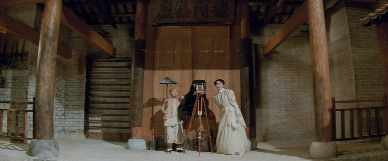 Once Upon a Time in China (1991) movie still: fullbody — An ancestral hall features large wooden pillars, brick walls, and intricate wooden doors. A…
