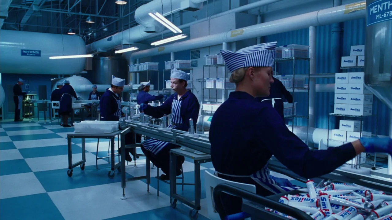 Charlie and The Chocolate Factory (2005) movie still: wide — A sterile industrial floor with a checkered blue and white floor and overhead pipes.…