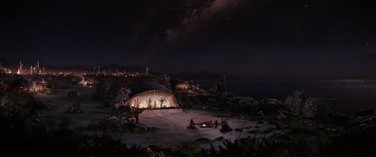 Cloud Atlas (2012) movie still: establishing — A coastal settlement features rounded dome structures along a beach under a starry sky. A small…
