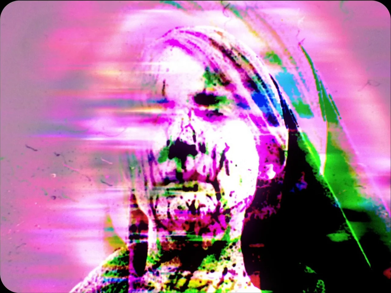 Longlegs (2024) movie still: closeup — An abstract frame featuring a human face severely distorted by digital chromatic aberration. The subject…