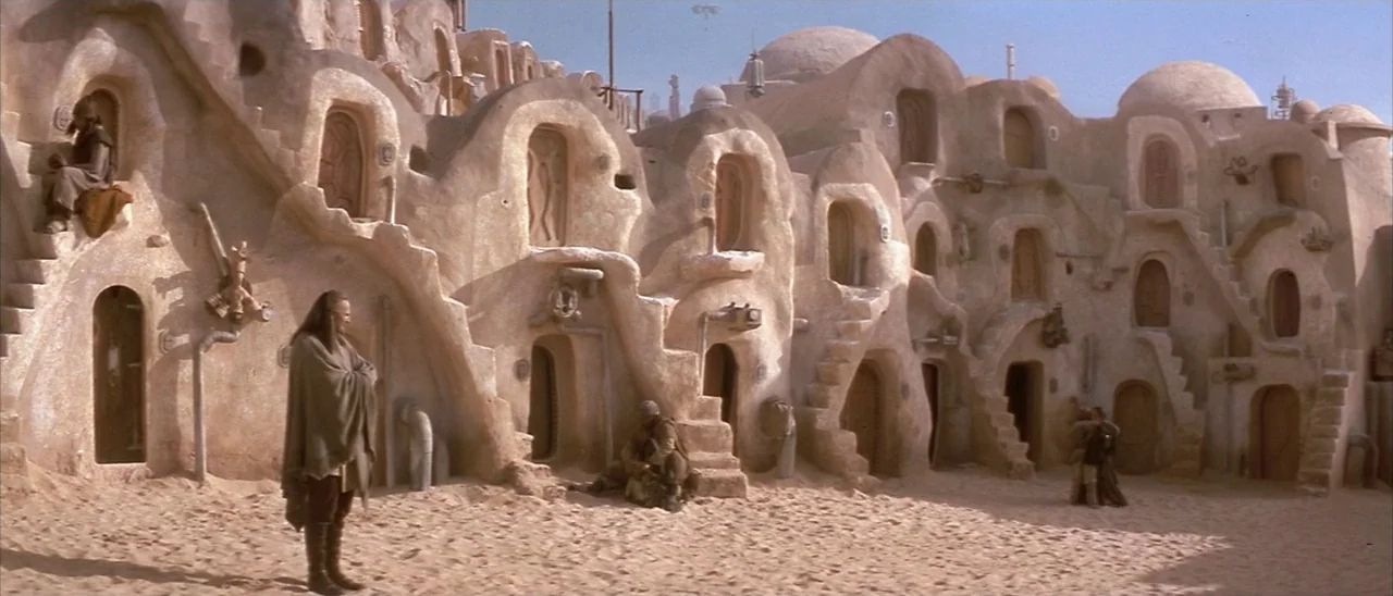 Star Wars: Episode I – The Phantom Menace (1999) movie still: wide — A complex of curved, mud-brick dwellings features multiple levels with…