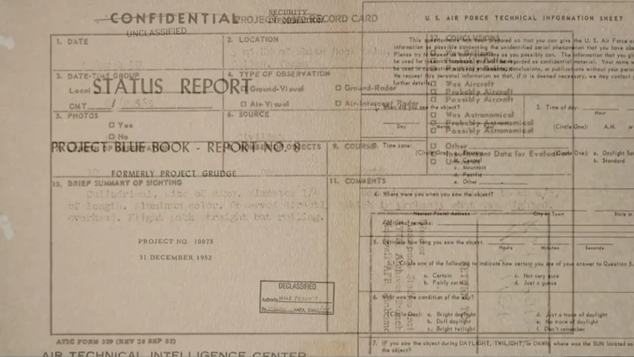 UFO Conspiracies: The Hidden Truth (2020) movie still: closeup — A declassified U.S. Air Force technical information sheet rests on a flat surface.…