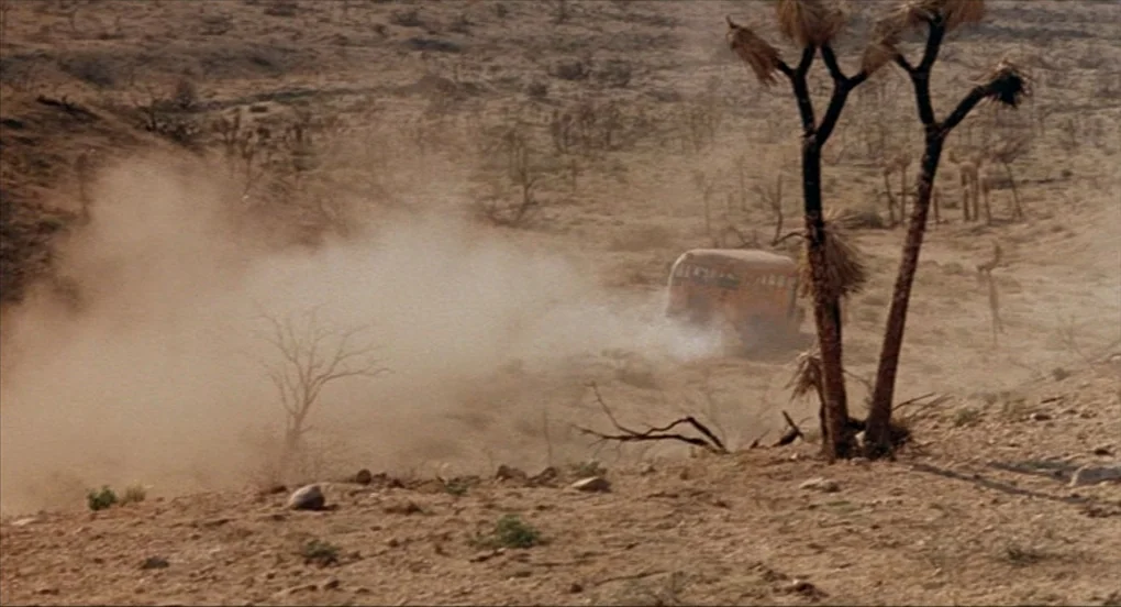 A Nightmare On Elm Street 2: Freddy’s Revenge (1985) movie still: wide — A vast, arid desert landscape features dry soil, scattered shrubs, and a…