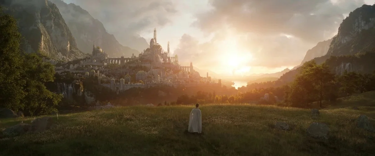 The Lord of the Rings: The Rings of Power (2022) movie still: wide — A sprawling fantasy city with white towers and spires sits in a deep valley. A…