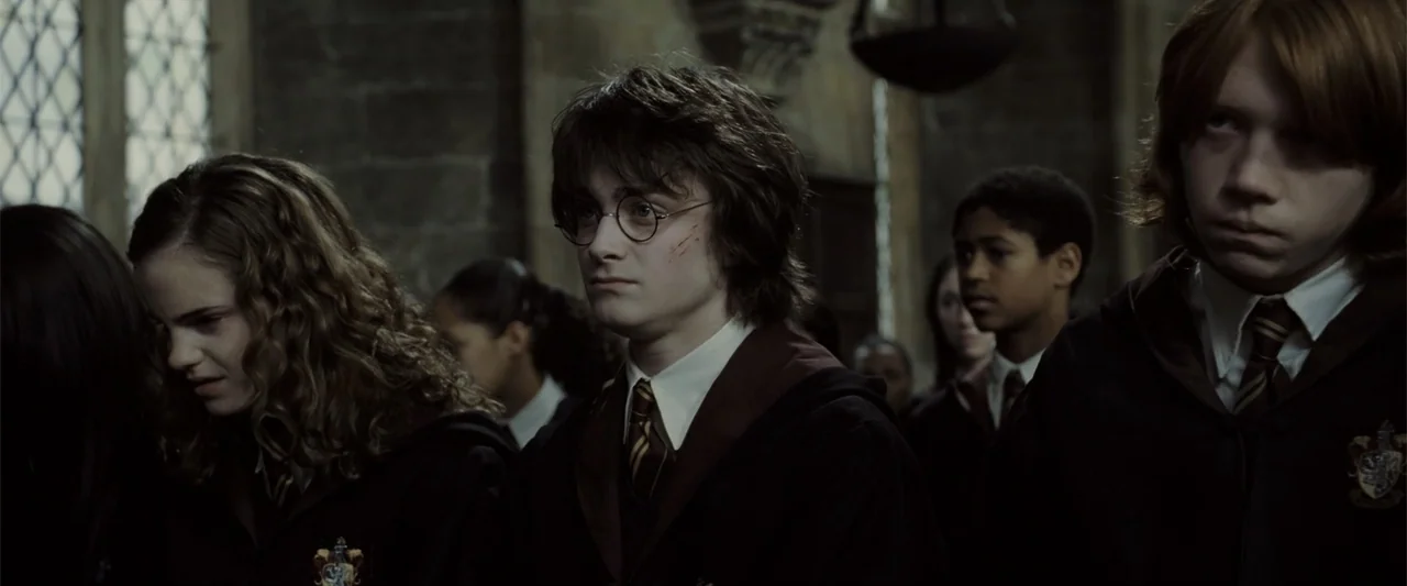 Harry Potter and the Goblet of Fire (2005) movie still: medium — A dark stone hall with high ceilings and small light-filtering windows along the…