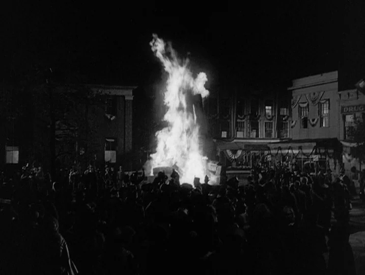 Young Mr. Lincoln (1939) movie still: wide — A crowd of people stands in a town square at night around a bonfire. The fire burns brightly in the…