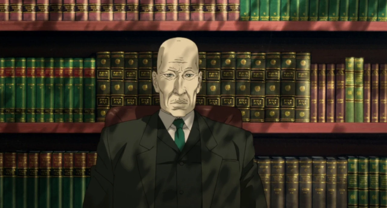 Paprika (2006) movie still: medium — A private home library features shelves densely packed with leather-bound books. An elderly man sits upright in…