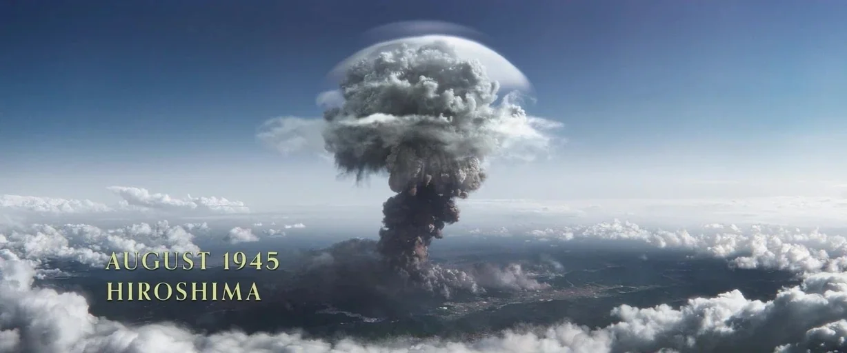 Eternals (2021) movie still: establishing — An aerial view shows a dense mushroom cloud rising above a distant landscape. Small white clouds drift…