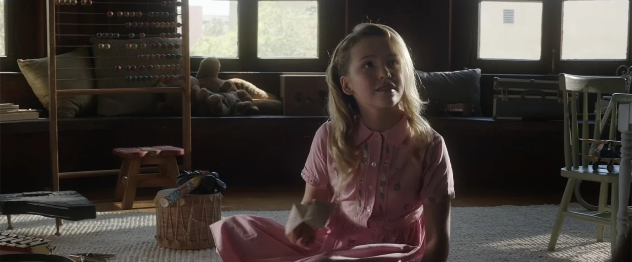Annabelle: Creation (2017) movie still: medium — A sunlit indoor playroom contains scattered toys, a wooden abacus, and a window seat. A blonde…