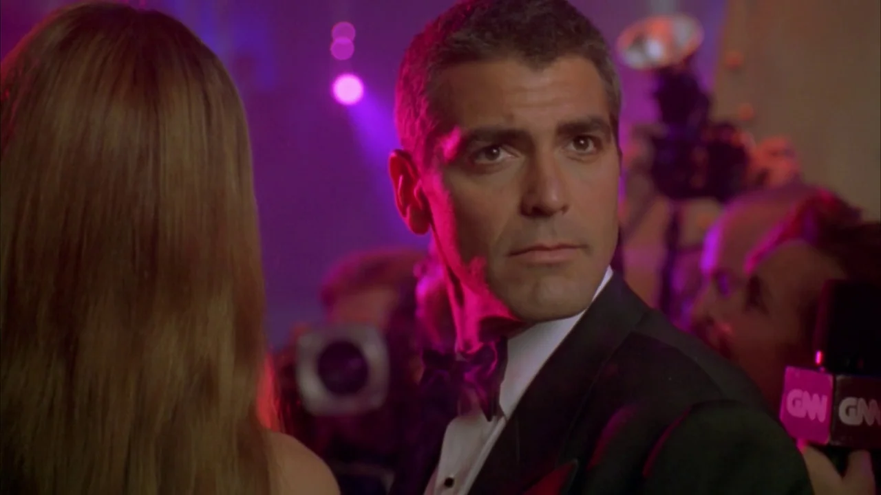 Batman & Robin (1997) movie still: medium — A crowded public event with photographers and reporters gathered in the dark night. A man in a tuxedo…