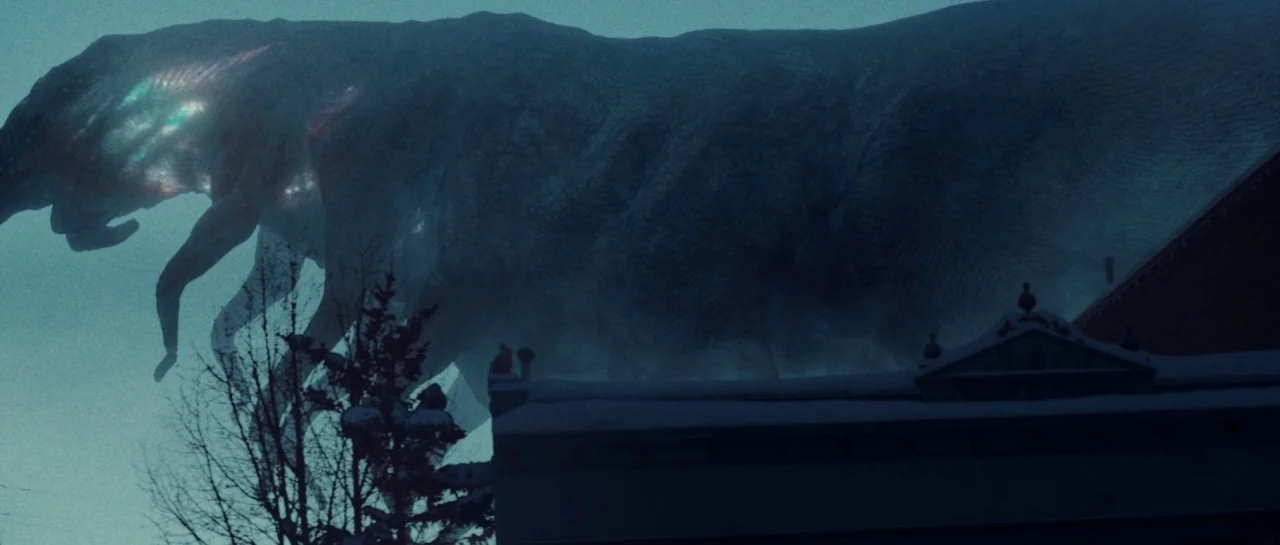 Starfish (2018) movie still: wide — A gargantuan creature with glowing bioluminescent patterns on its side looms over neighborhood rooftops. The…