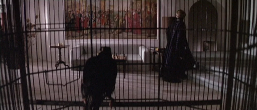 Boom! (1968) movie still: medium — A spacious room features a large historical tapestry on the wall behind a couch. A dark-colored bird rests on a…