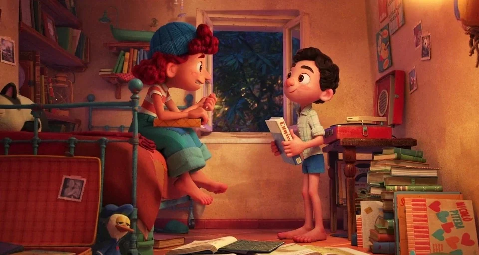 Luca (2021) movie still: medium — A cluttered child's bedroom features wooden shelves, stacks of books, and an open window. A young girl sits on the…