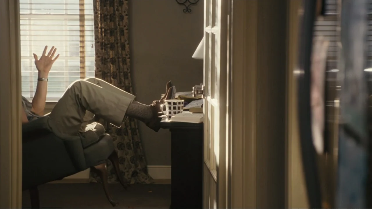 Fun with Dick and Jane (2005) movie still: medium — A residential room features a desk near a window with sunlight streaming through blinds. An…