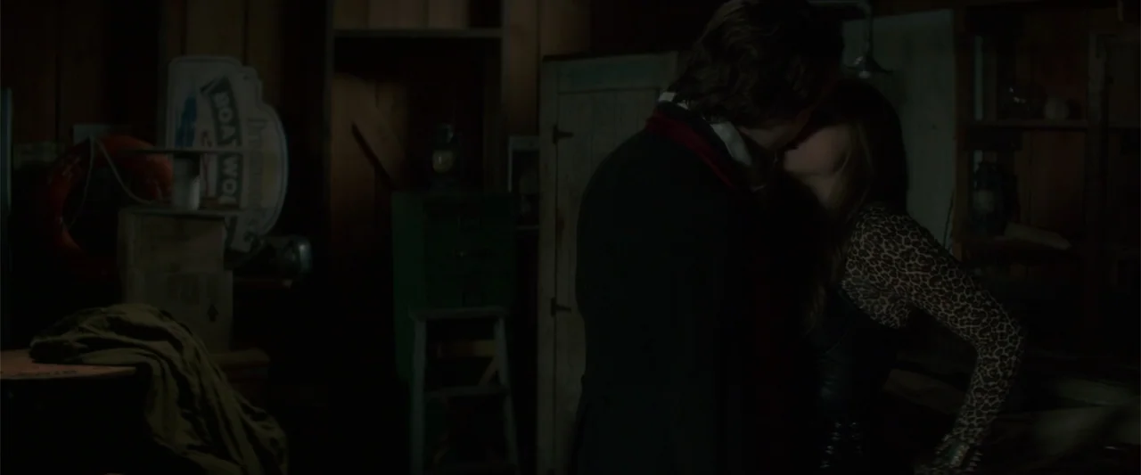 If I Stay (2014) movie still: medium — A cluttered storage room features wooden walls, old boxes, and miscellaneous gear in low light. A man and a…