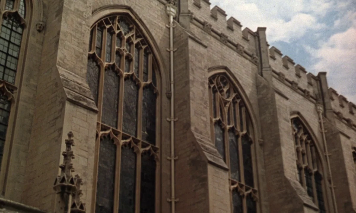 If…. (1968) movie still: establishing — A gothic cathedral exterior features ornate stone windows and crenellated roof battlements. The limestone…