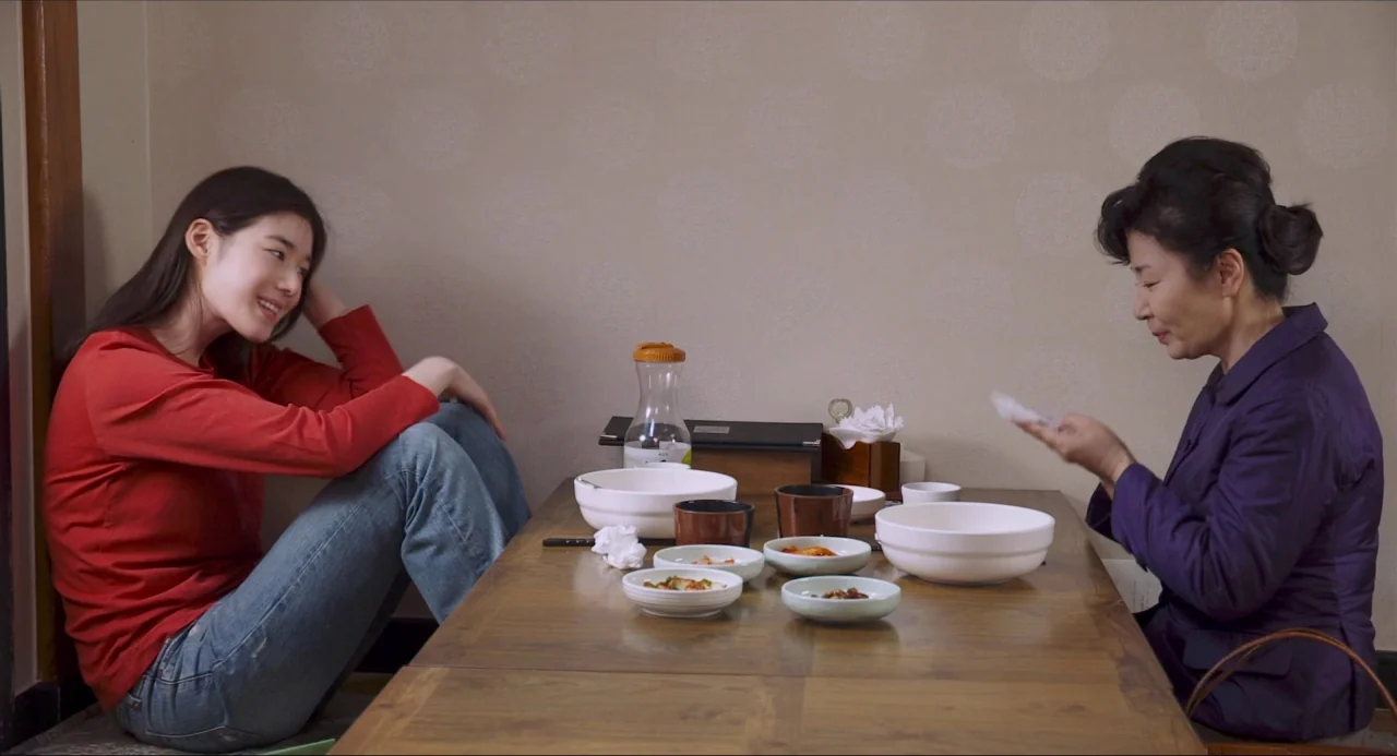 Nobody’s Daughter Haewon (2013) movie still: medium — A small dining table in a room with beige, patterned wallpaper.