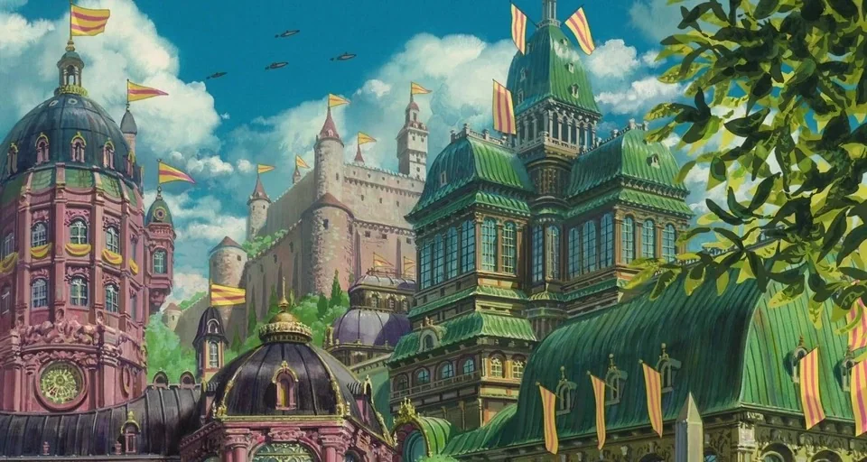 Howl’s Moving Castle (2004) movie still: establishing — A complex fantasy city features ornate pink and green towers under a blue sky. Numerous…