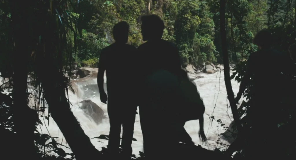 My Son, My Son, What Have Ye Done? (2009) movie still: fullbody — Dense tropical foliage frames a rushing muddy river flowing over rocks and rapids.…