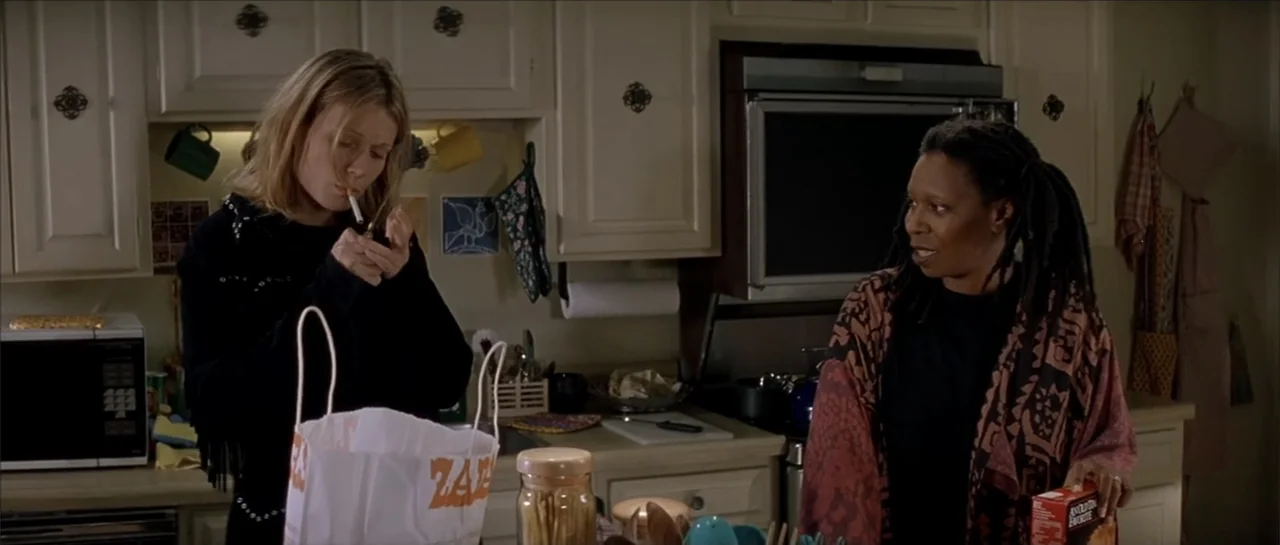 Moonlight and Valentino (1995) movie still: medium — A residential kitchen features light-colored cabinetry and a cluttered counter with groceries…