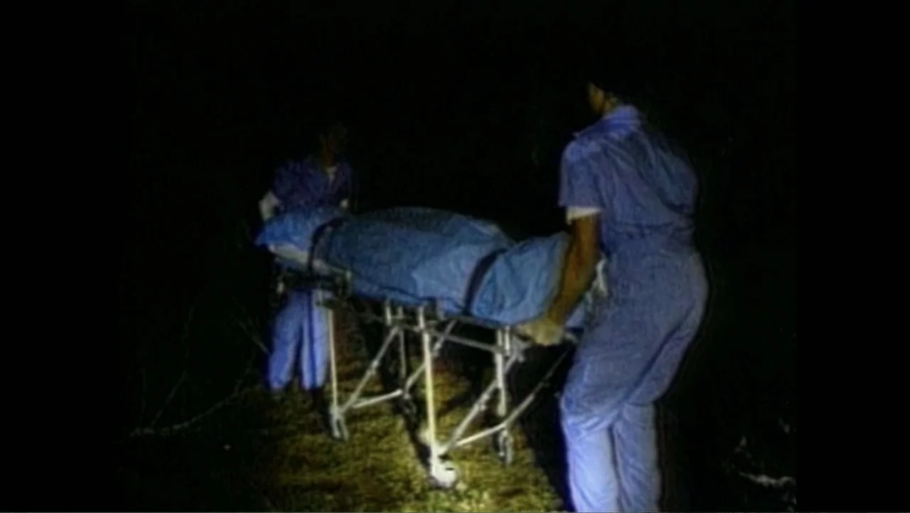 Aileen Wuornos : Mind of a Monster (2020) movie still: medium — A dark, grassy field at night is lit by a harsh, single directional light source.…