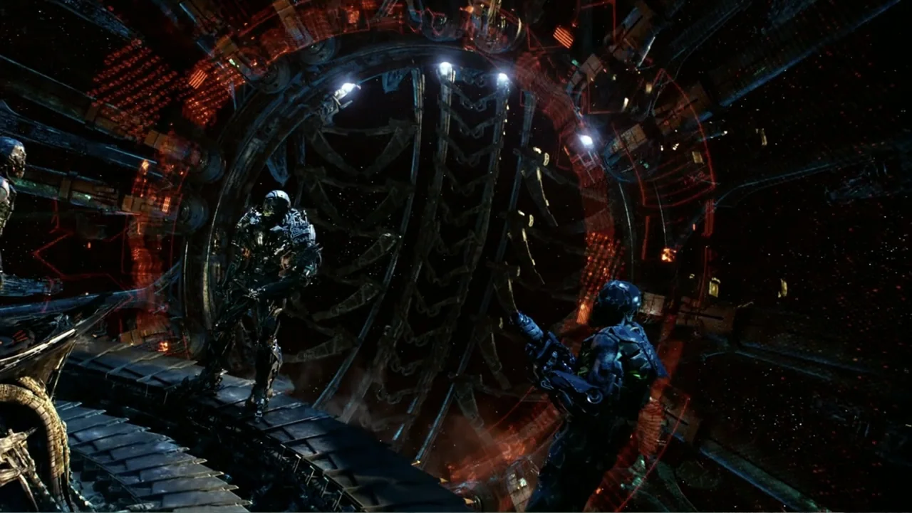 Transformers: Age of Extinction (2014) movie still: wide — A dark, circular metallic interior with intricate mechanical rings and red holographic…