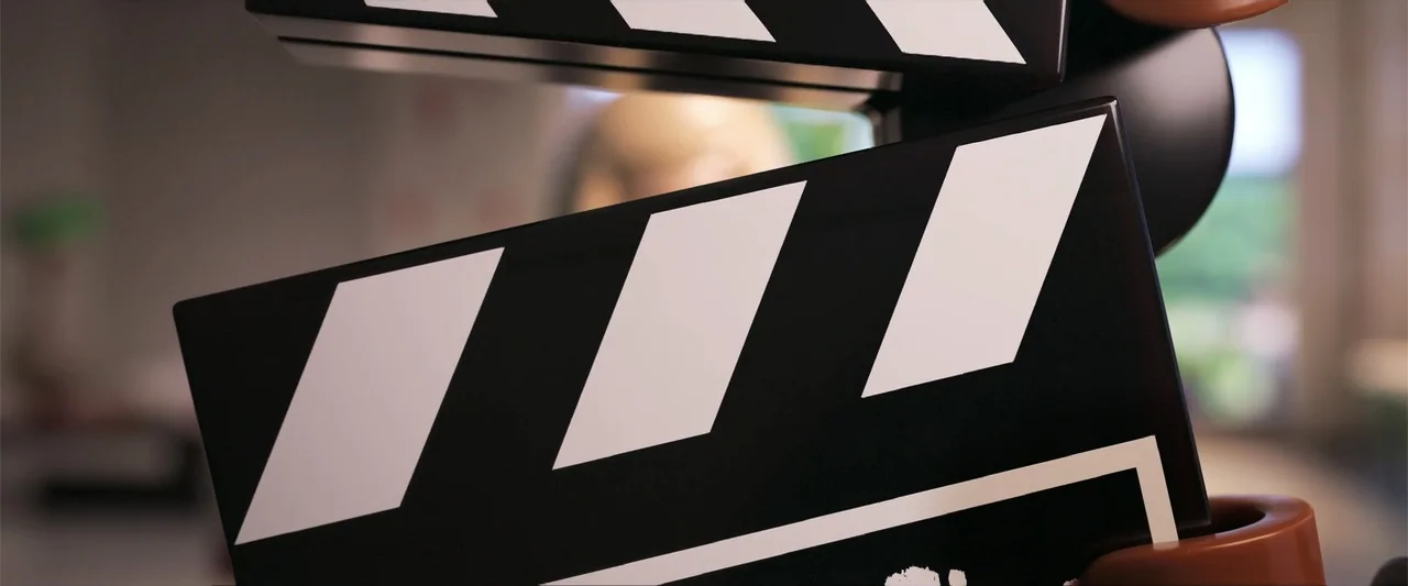 Piece by Piece (2024) movie still: closeup — A film set interior with a blurred background showing an out-of-focus humanoid figure. A large black…