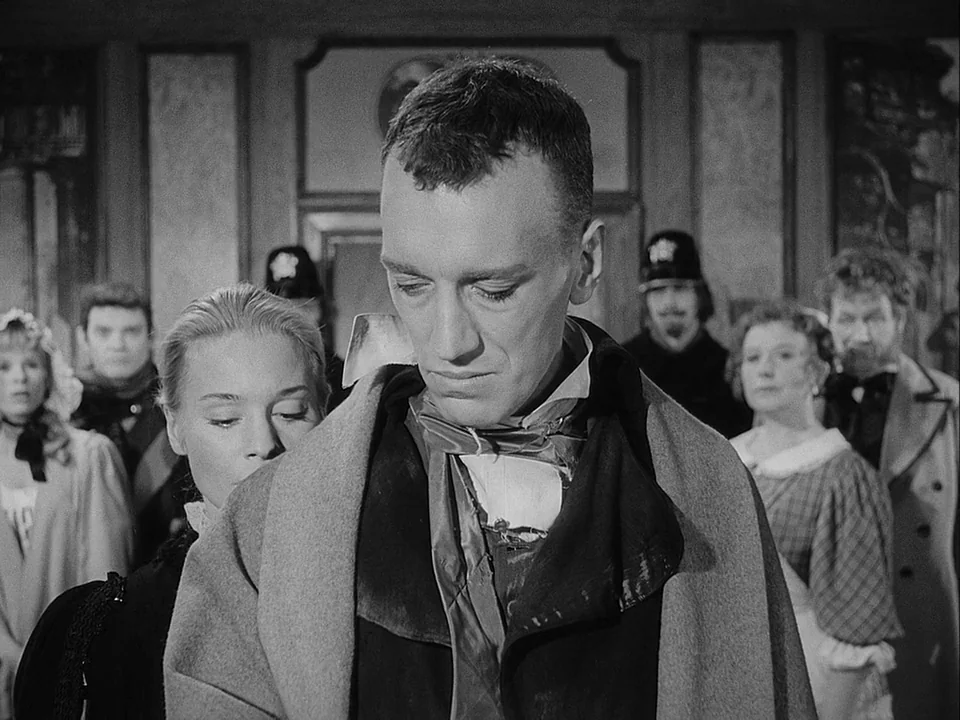 The Magician (1958) movie still: medium — A group of people dressed in early twentieth-century formal attire stand in a hall. A man in the…