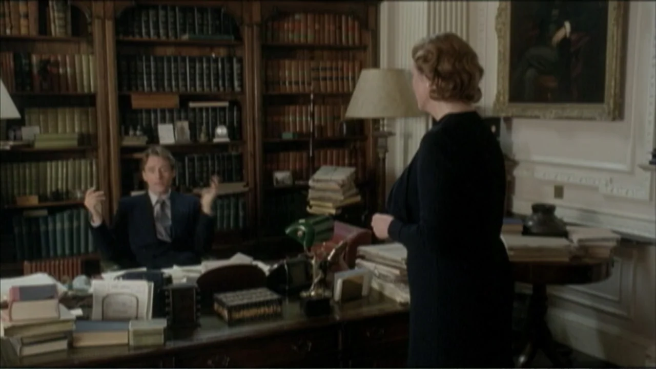 The Gathering Storm (2002) movie still: medium — A traditional wood-paneled library contains floor-to-ceiling bookshelves and a large mahogany desk.…