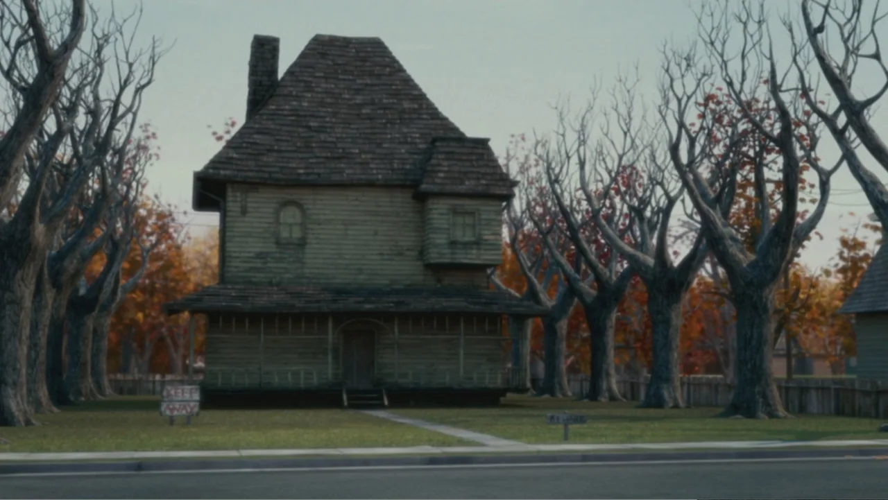 Monster House (2006) movie still: establishing — A wooden two-story house with a shingled roof sits behind a low fence. Tall gnarled trees without…
