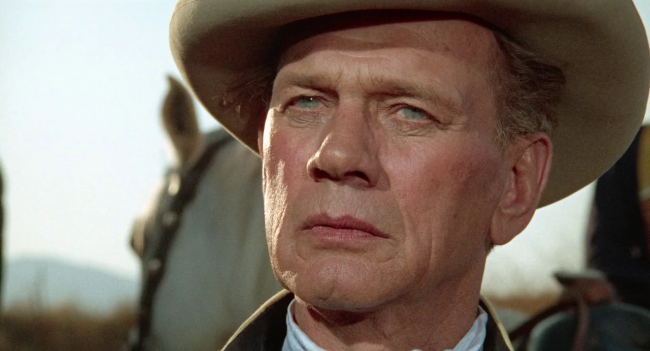 The Hellbenders (1967) movie still: closeup — A man wearing a tan hat stands outdoors in a bright prairie environment. He faces forward with a…