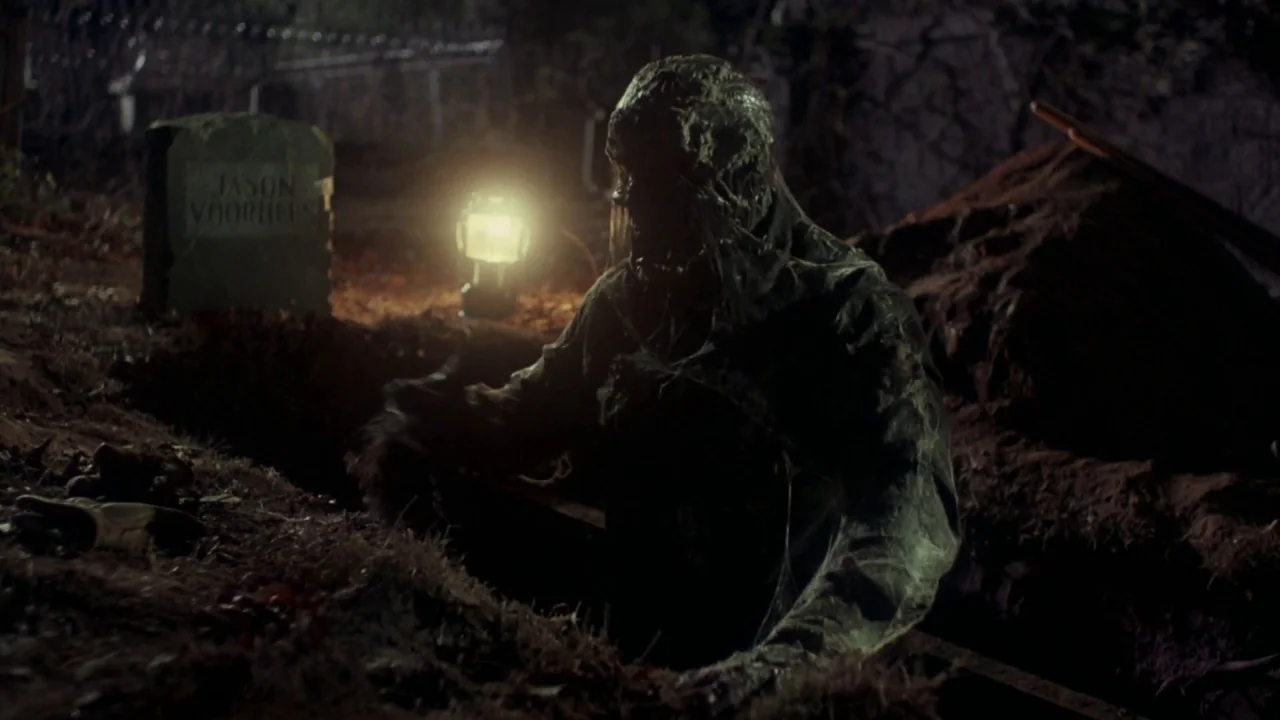 Friday the 13th Part VI: Jason Lives (1986) movie still: medium — A nighttime scene in a graveyard showing an open grave with a headstone. A…